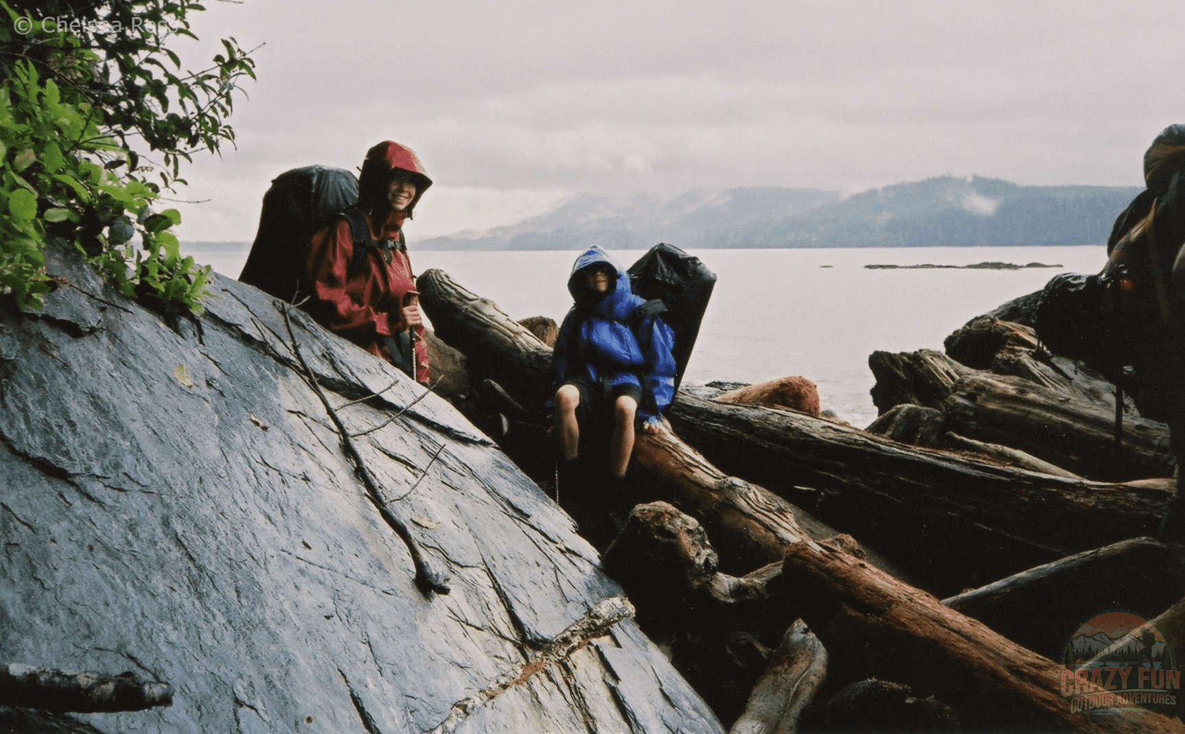 boy and girl over logs and boulders