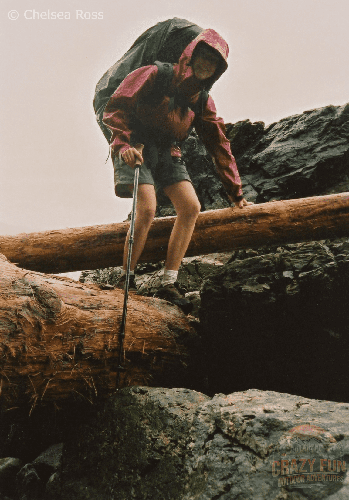 West Coast Trail tips: Beware of boulders and logs on the trail. Girl going on top of rocks having to hop over logs as we hike on the beach backpacking the West Coast Trail