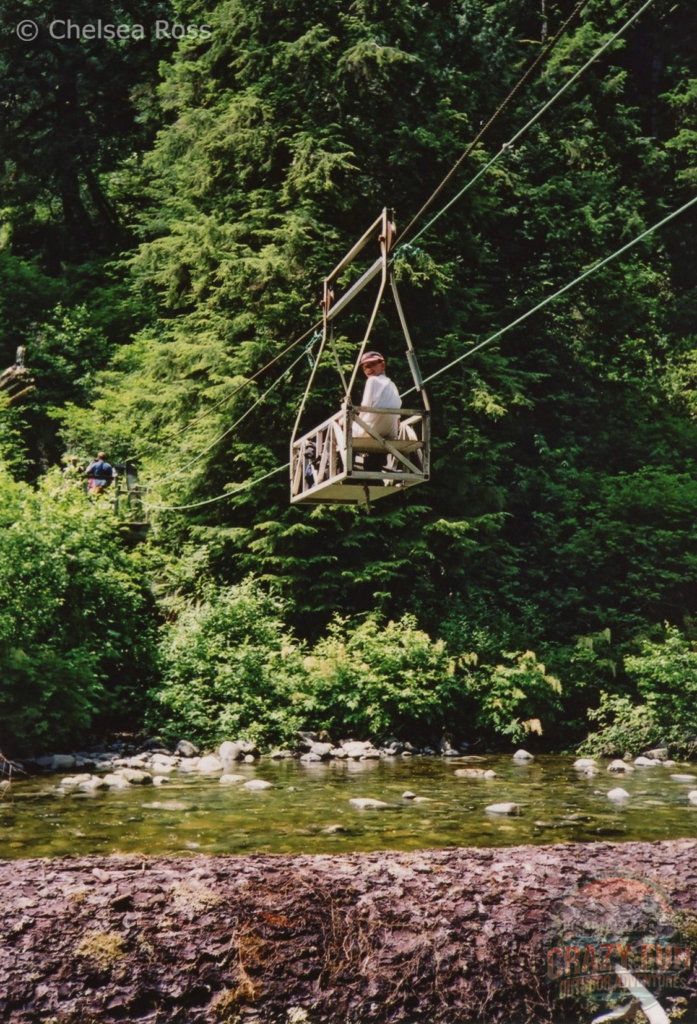 boy in a cable car crossing the river