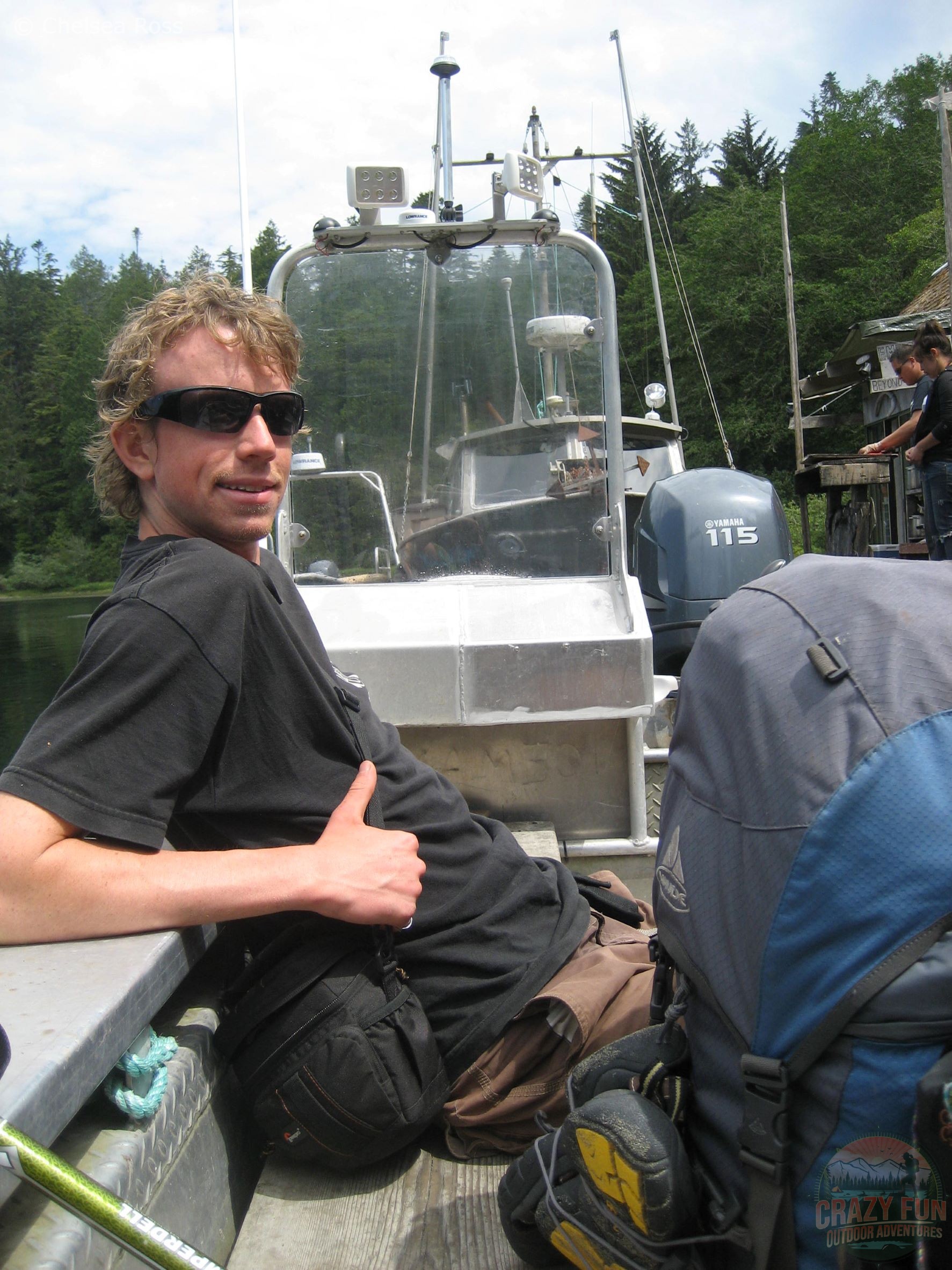 young male adult riding ferry with his backpack beside him