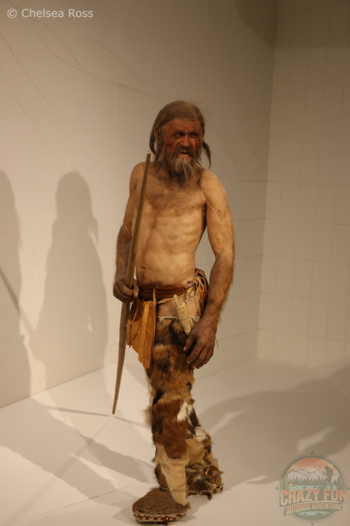 Ötzi, the ultimate hiker (recreated) posing at the Iceman museum on our Unforgettable Hiking Holiday in Bolzano.