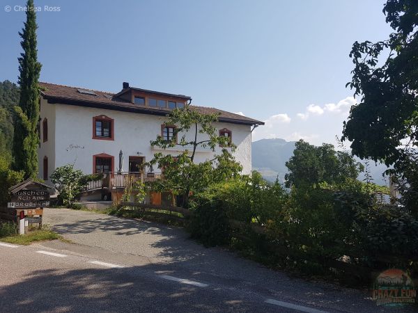 Gruberhof, a white bed and breakfast house where we stayed in the foothills north of Bolzano with a road leading up to it.