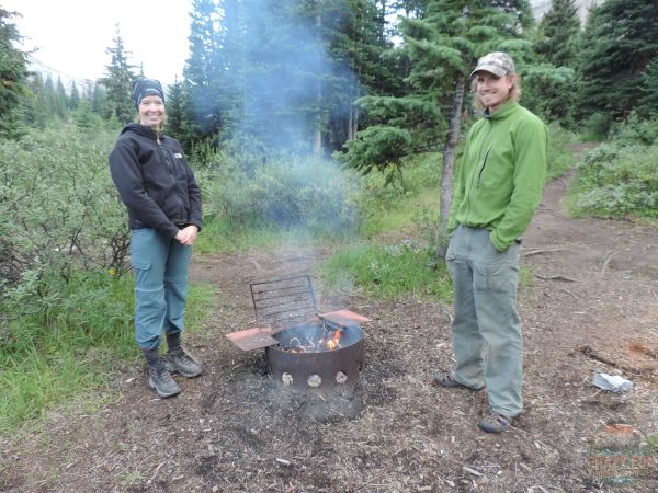 Two people warming up beside the fire