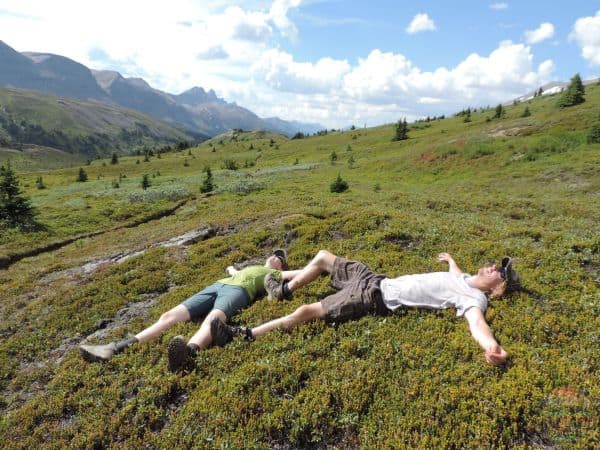 My brother and I lying in the moss in the sun enjoying the nice heat.