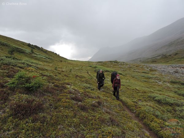 Two backpackers with their rain gear after passing through a rain storm.