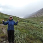 Lady stays positive backpacking in the rain.