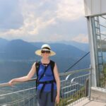 Lady in front of the Vilpian-Mölten Cable car overlooking the town of Vilpian in the valley during our hiking holiday in Bolzano.