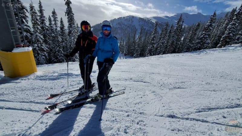 A couple skiing off Canadian Rockies Express Quad Chair at Marmot Basin in Jasper.