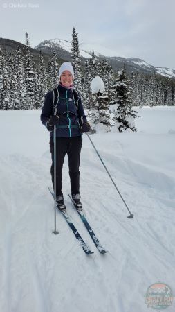 Lady standing on cross-country skis wearing her Merino pant base layer underneath her black fleece pants.  