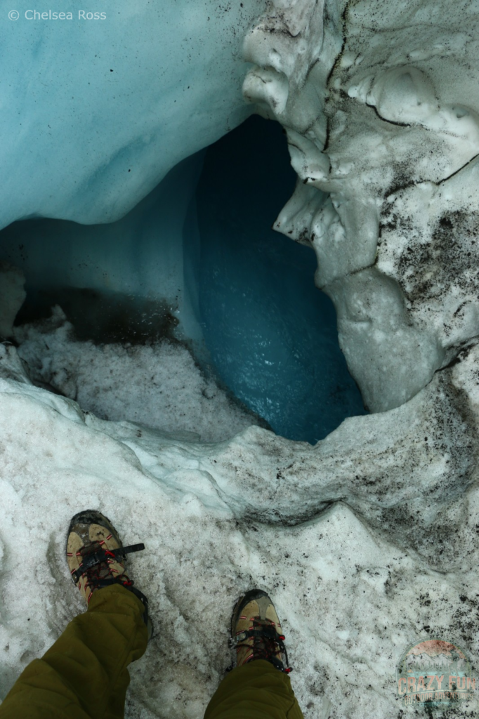 Athabasca Glacier Hike: Big crevasses throughout the glacier can be seen such as this one. Water is flowing in river form down below in the crevasse. 