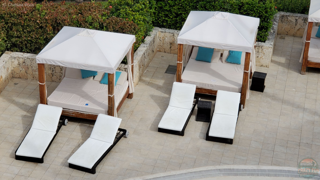 10 Tips to Avoid Sunburn: Bali beds we used to relax by the pool. Two individual chairs sit in front of the Bali beds as well. 