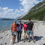 Best Hiking Gifts for Dads: Arctyrx shorts that my brother is wearing to the far right. My parents and I are to the left of my brother with Minnewanka Lake behind us.