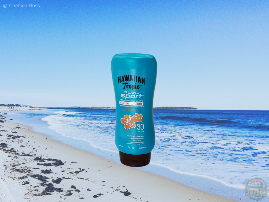 A picture of water resistant sunscreen with the beach as the background.