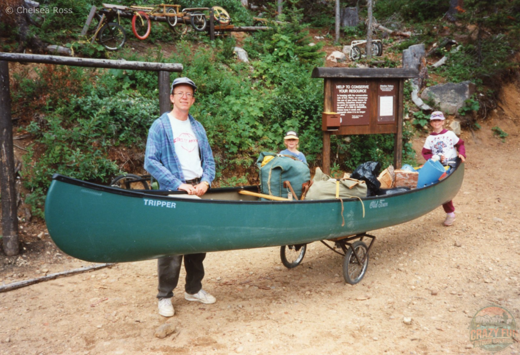 Portaging to Murtle lake. The canoe is on wheels with my dad, brother and myself pushing.