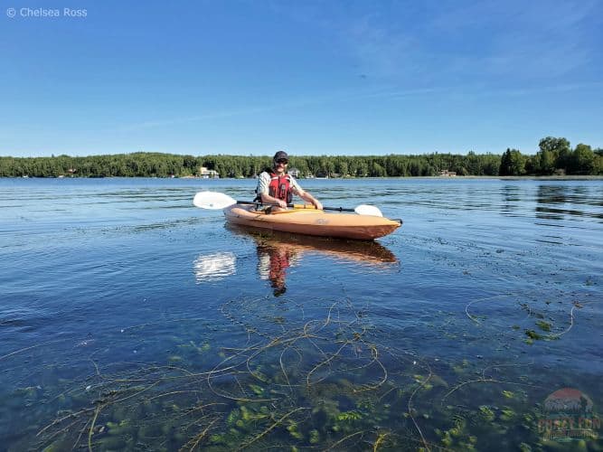 Kris sitting in his kayak on the water