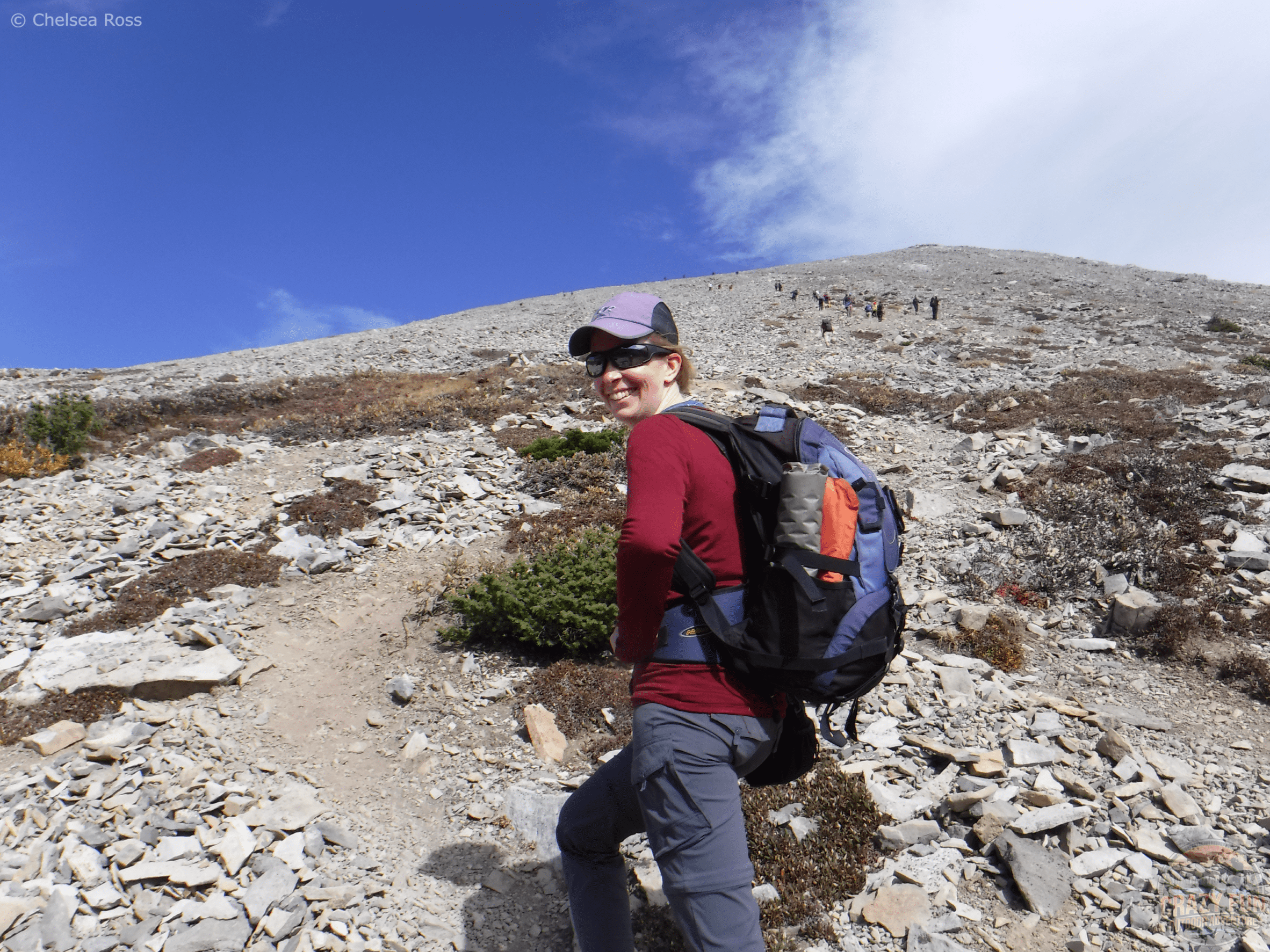 I'm hiking in my maroon merino long sleeve shirt. My orange MEC seat cushion can be seen on the left side of my backpack pocket.