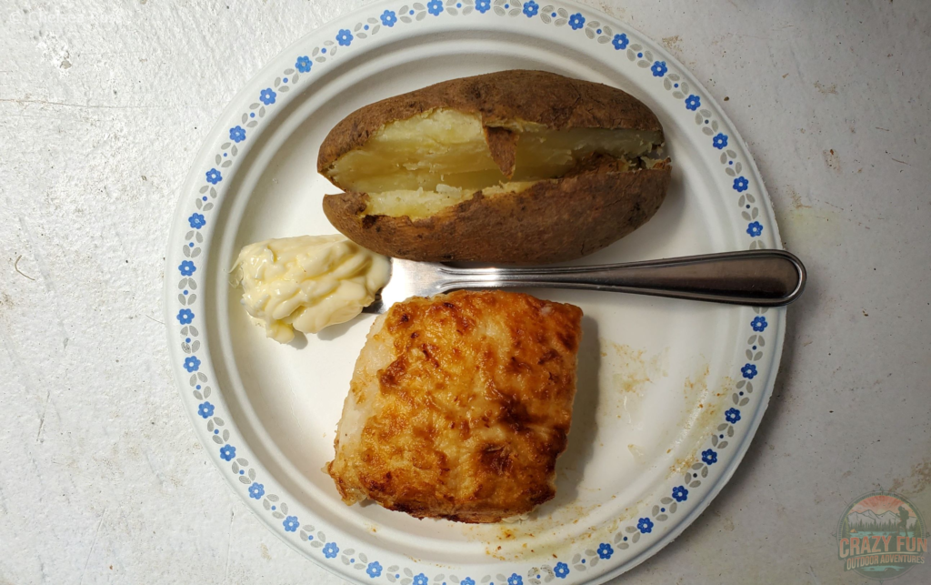 Eating halibut, margarine and a baked potato from the Crab Shack.
