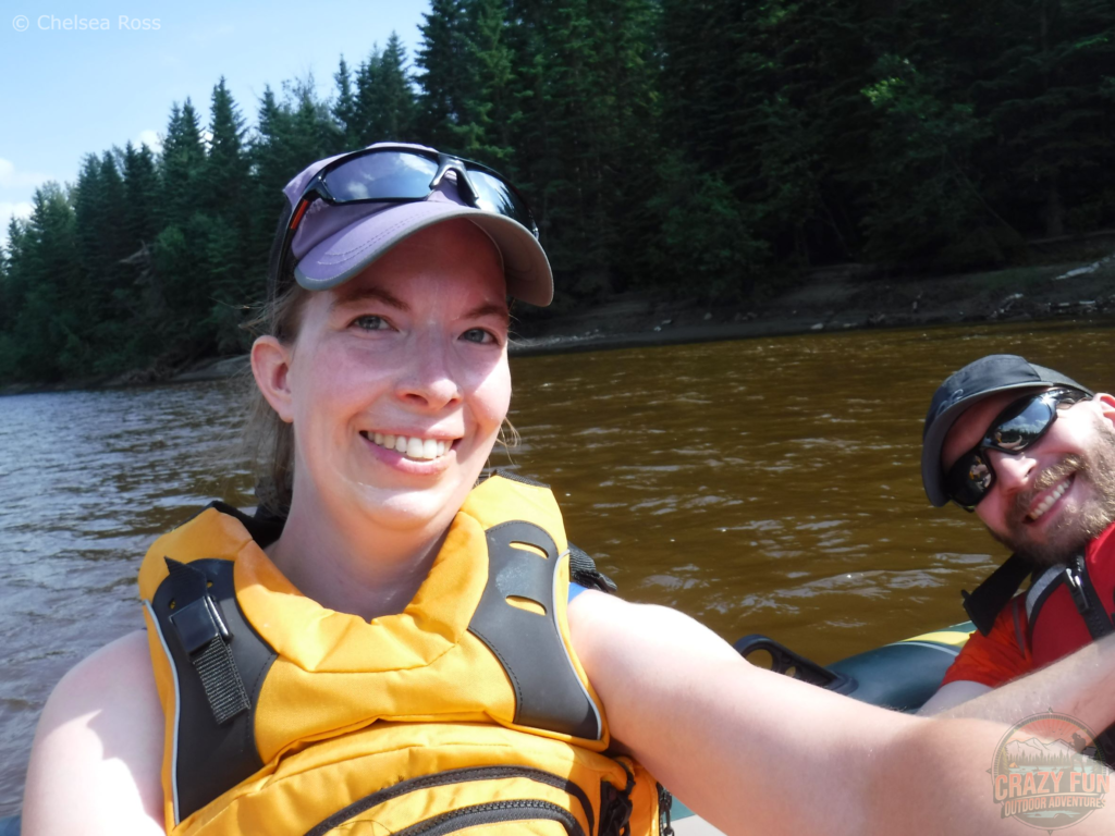 Edmonton Day Trips: Rafting down the Pembina River with Mel and Kris. I'm wearing a yellow PFD, purple hat and black sunglasses. Kris is wearing a red PFD and shirt with black sunglasses and hat. 