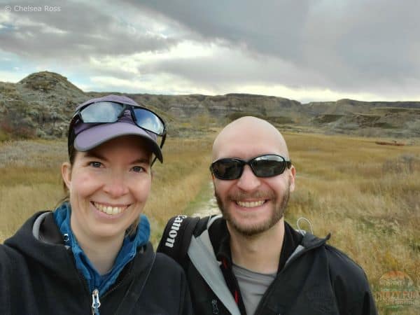 Two hikers with the Drumheller foothills in the back.