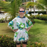 Wearing a light cotton poncho with a large neck and arm opening to keep the hot air circulating around me but also helping to treat a sunburn.