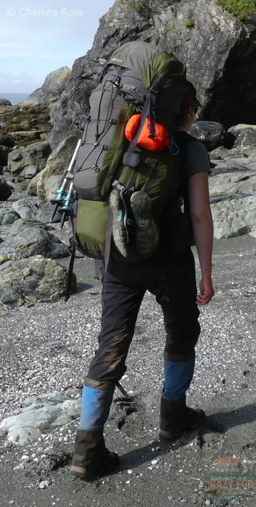 I'm wearing a green backpack with sandals clipped to the back of my pack.