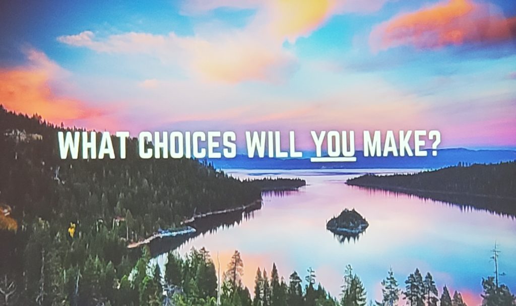 A picture with white writing that says What choices will you make? It's from Colin West's presentation Clean Up the Lake. 