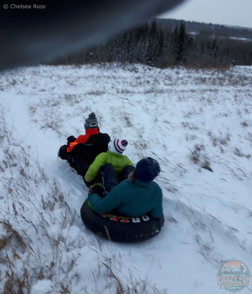 Kris, my mom and I are tubing and sledding down the hill attached together.