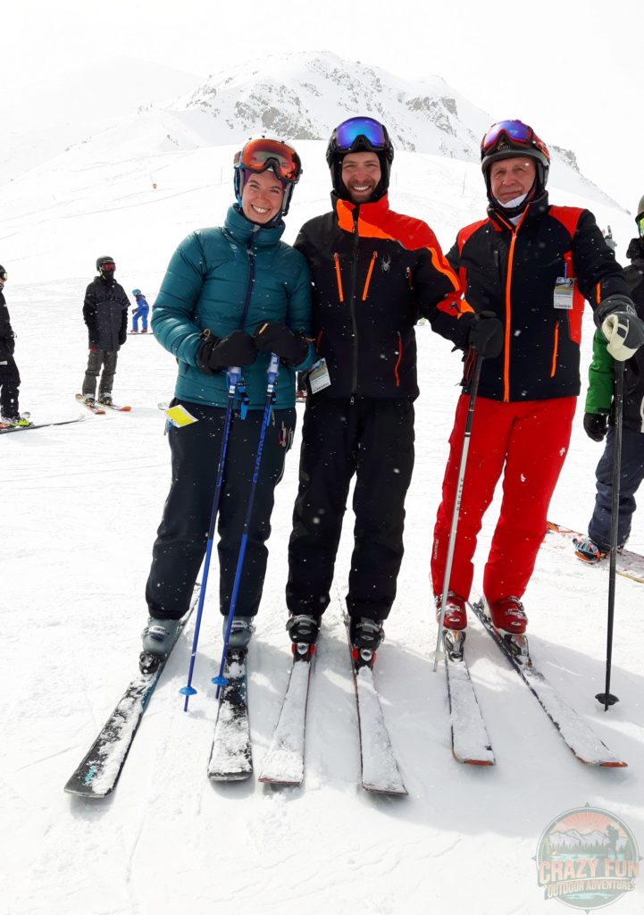 A picture of the three of us at the top of the mountain ready to go downhill skiing.