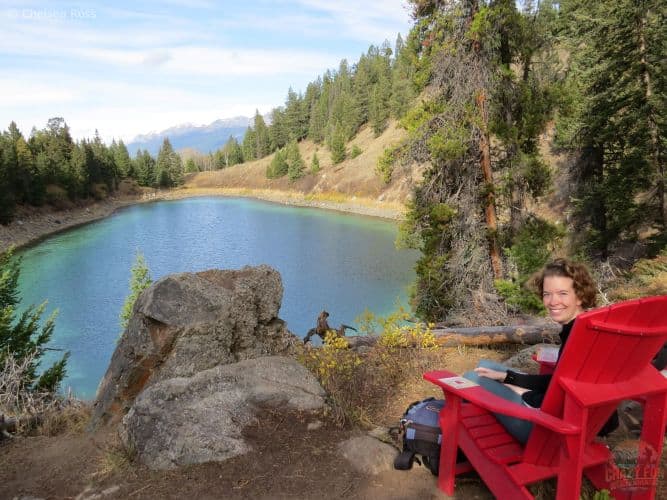 Lady sitting in a red chair overlooking the third lake.