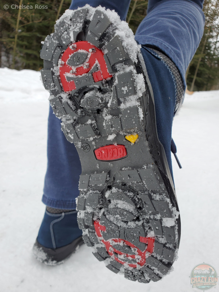 Showing the Olang Parigi 2.0 Spike Boot with the spikes pointed out for traction against the ice and snow.