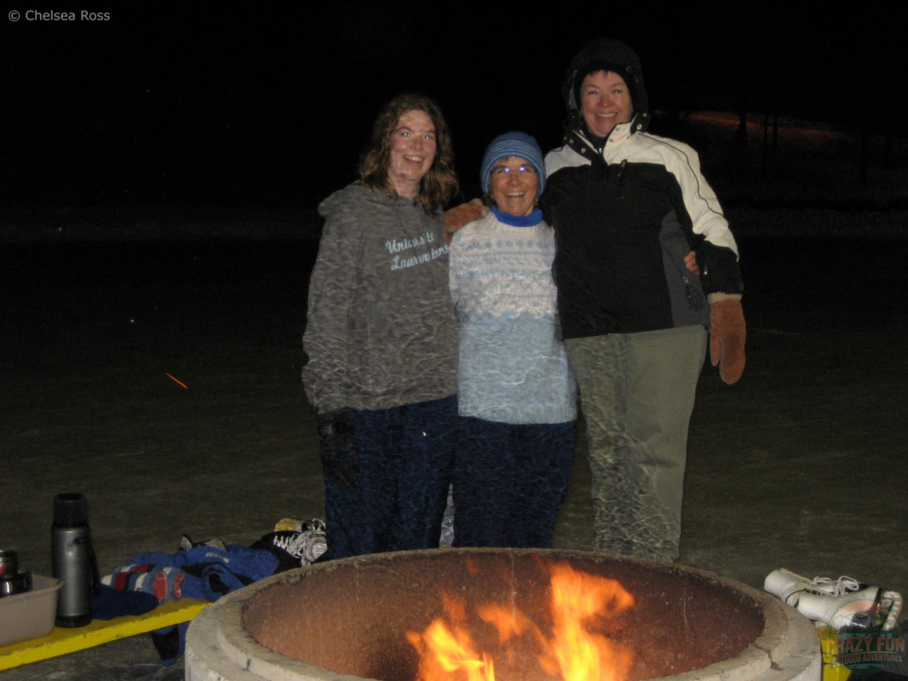 Ways to spend time outdoors: enjoying a fire outside. My mom, grand-maman and I standing behind a roaring fire outside while skating. 