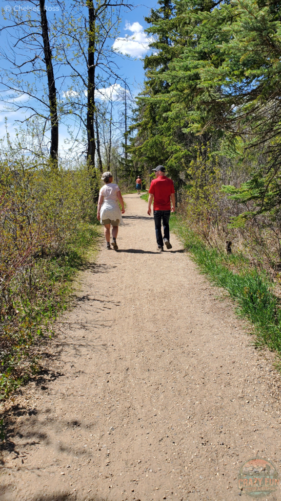 My mom and Kris walking along a gravel path.