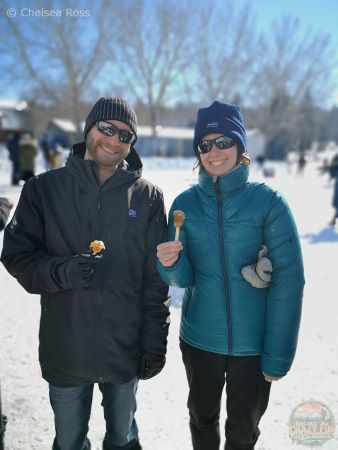 A couple holding our Maple taffy at La Cabane à Sucre.