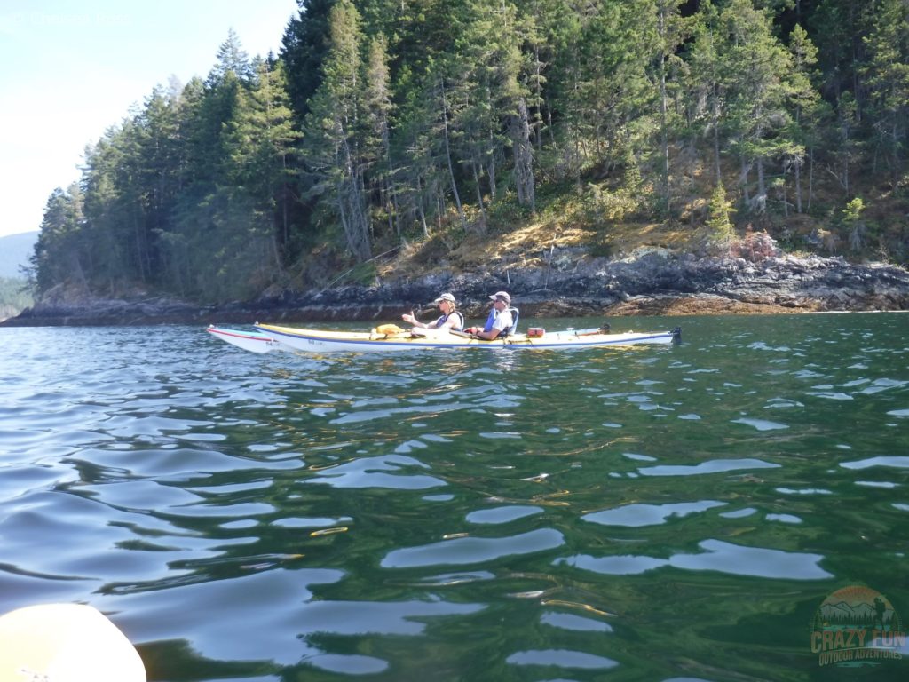 Two men are in their kayaks looking at a map navigating the group to our next destination. 