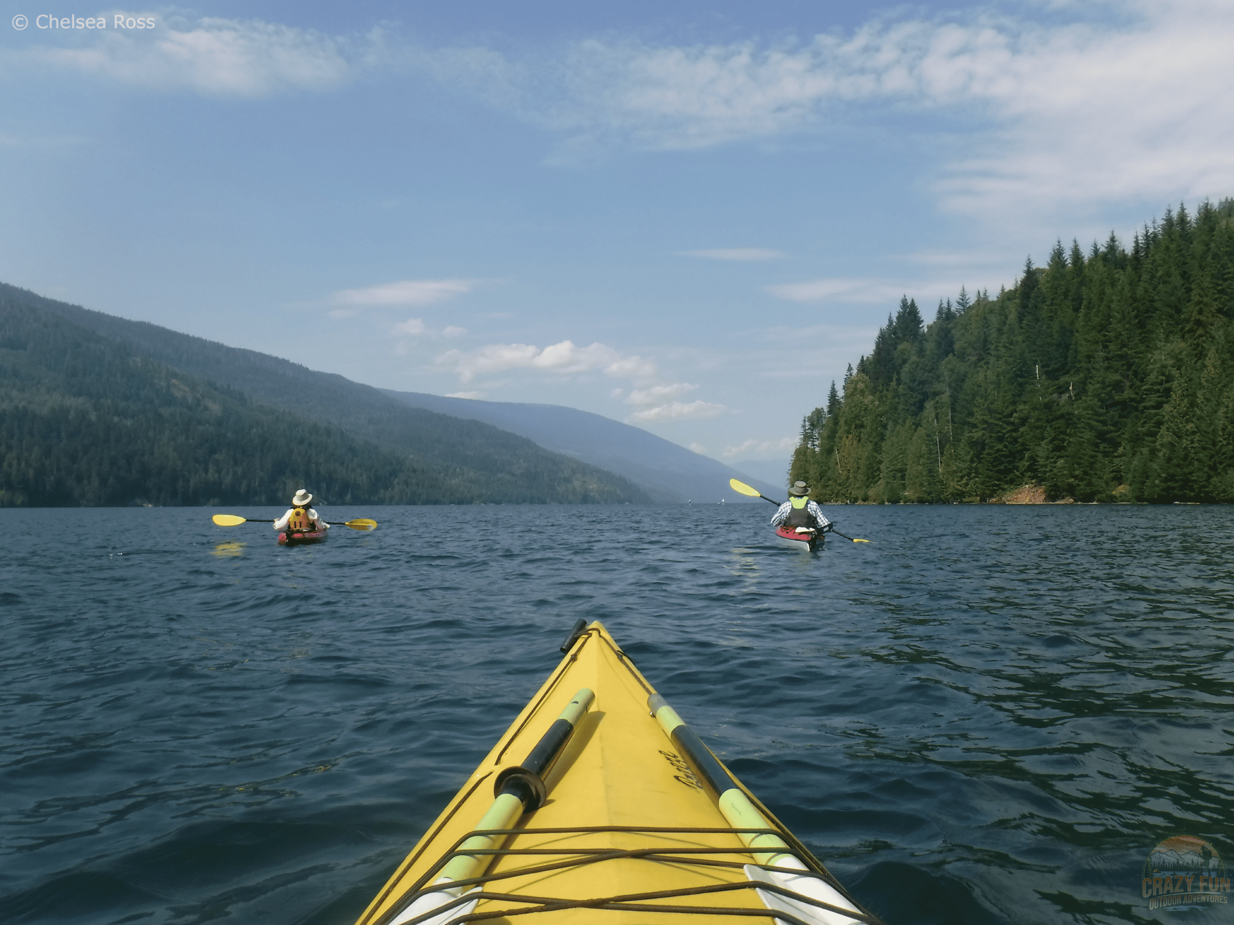My parents are in front of me while we kayak on Lake Revelstoke.