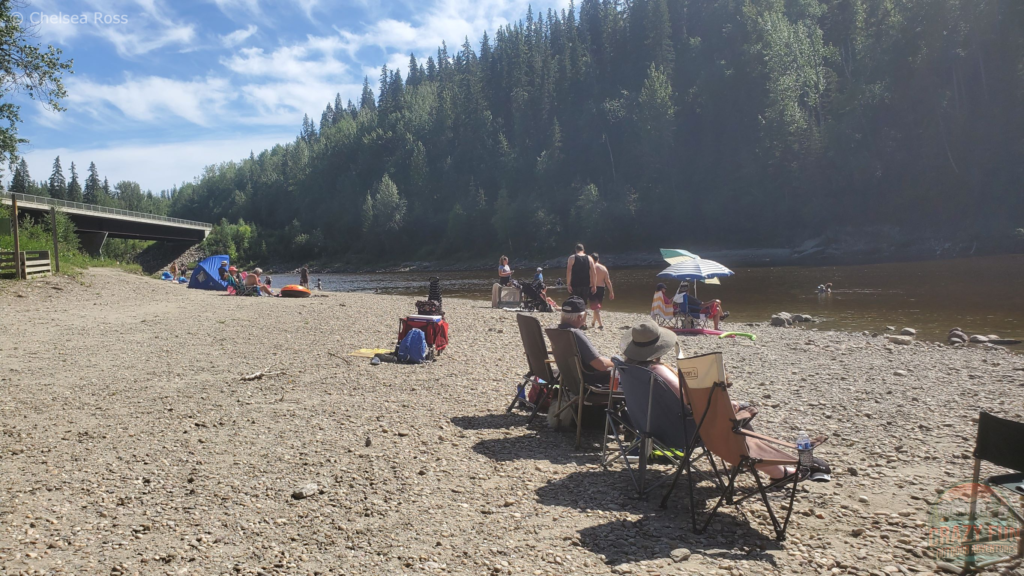 Pembina River with people sitting on chairs.