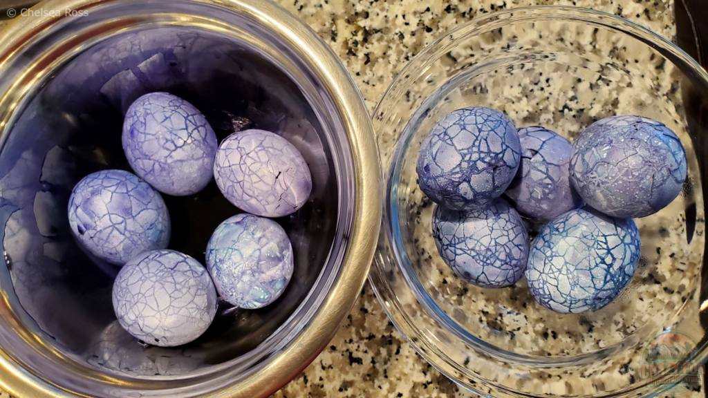Spooky deviled eggs being put in the purple dye.