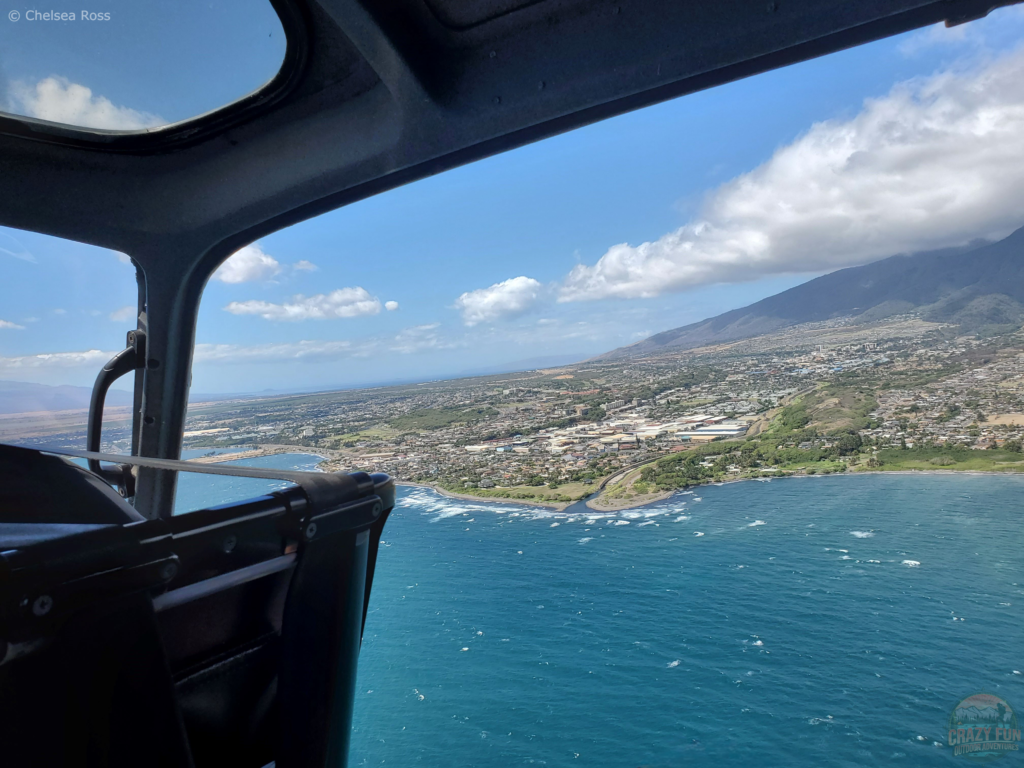 Looking out an open-door helicopter while on a ride.
