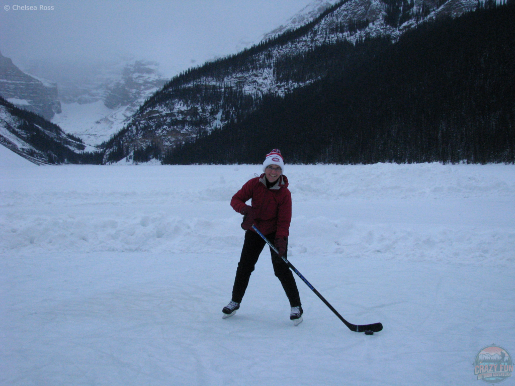 Lady playing hockey on Lake louise