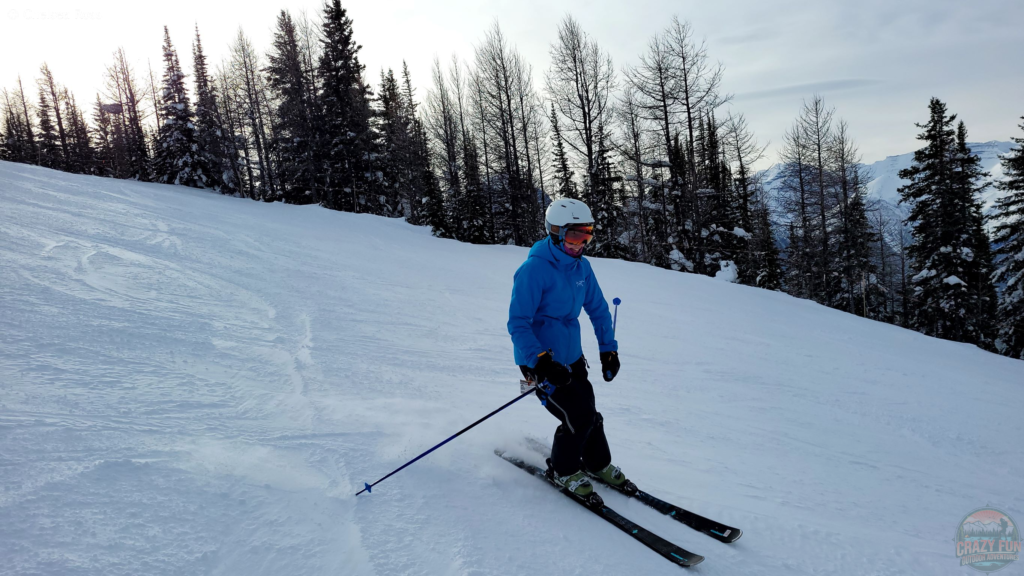 Enjoy winter wonderland in Banff downhill skiing. Lady skiing down the slope.