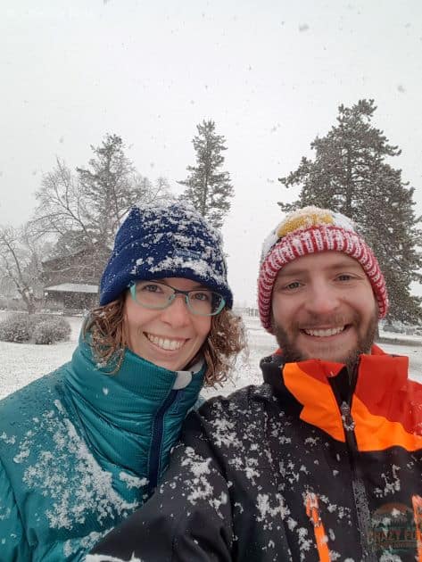 Romantic winter Jasper hikes shows big snowflakes falling on a couple.
