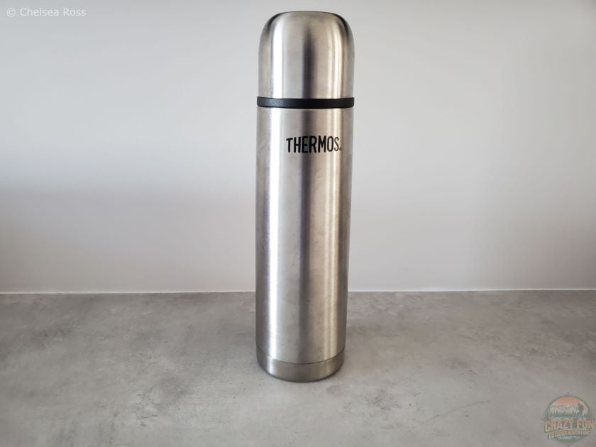 A gray thermos to hold hot beverages such as hot chocolate, tea or coffee. 