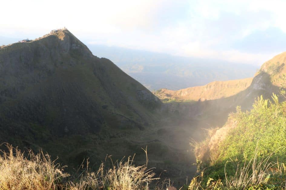 Mount Batur Sunrise Hiking Guide shows the crater of the volcano steaming as we walk along the top of the mountain to explore. 