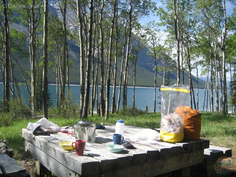 Backpacking gear on top of a picnic table while backpacking Lake Minnewanka during Four Seasons in Banff National Park.