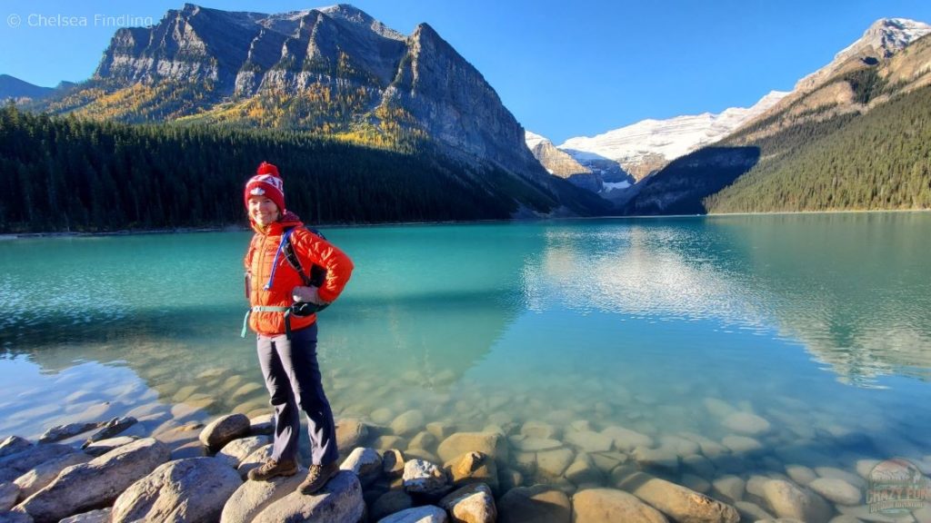 Overlooking Lake Louise with a person standing in the picture. 