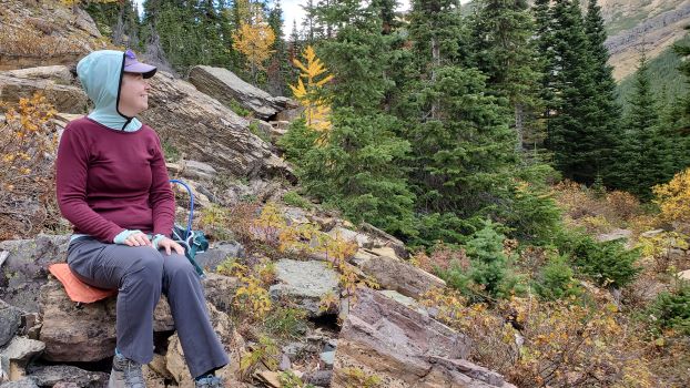 Merino wool red and green shirt on lady while sitting at Lower Rowe Lake.