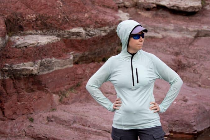 Lady wearing Minus 33 merino wool Sun Hoodie.