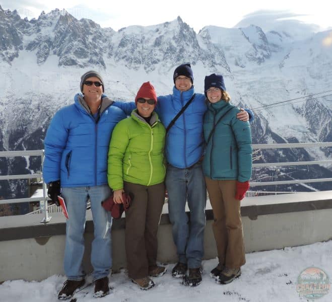 Family picture above the Brévent Cable Car overlooking mountains. 