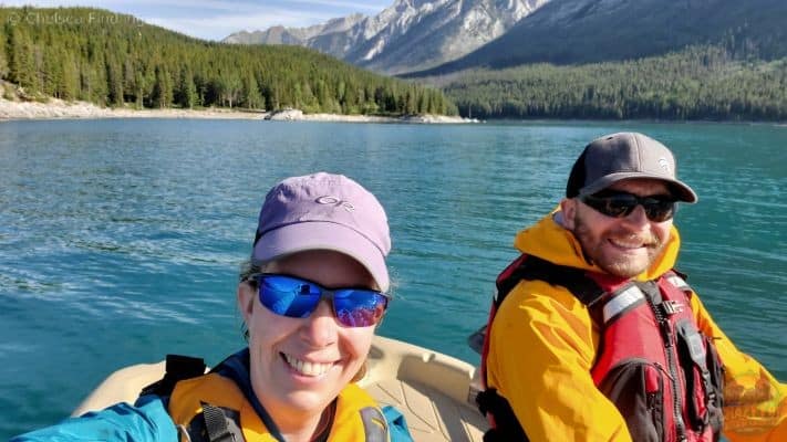 Selfie of a couple kayaking on Lake Minnewanka.