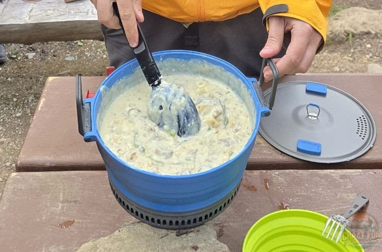 Pot filled with creamy Hamburger Helper Stroganoff on a picnic table.